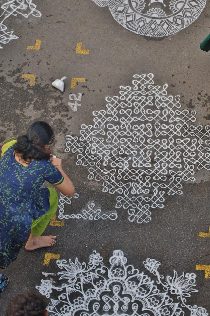 Traditional pulli kolam being drawn at Mylapore Festival